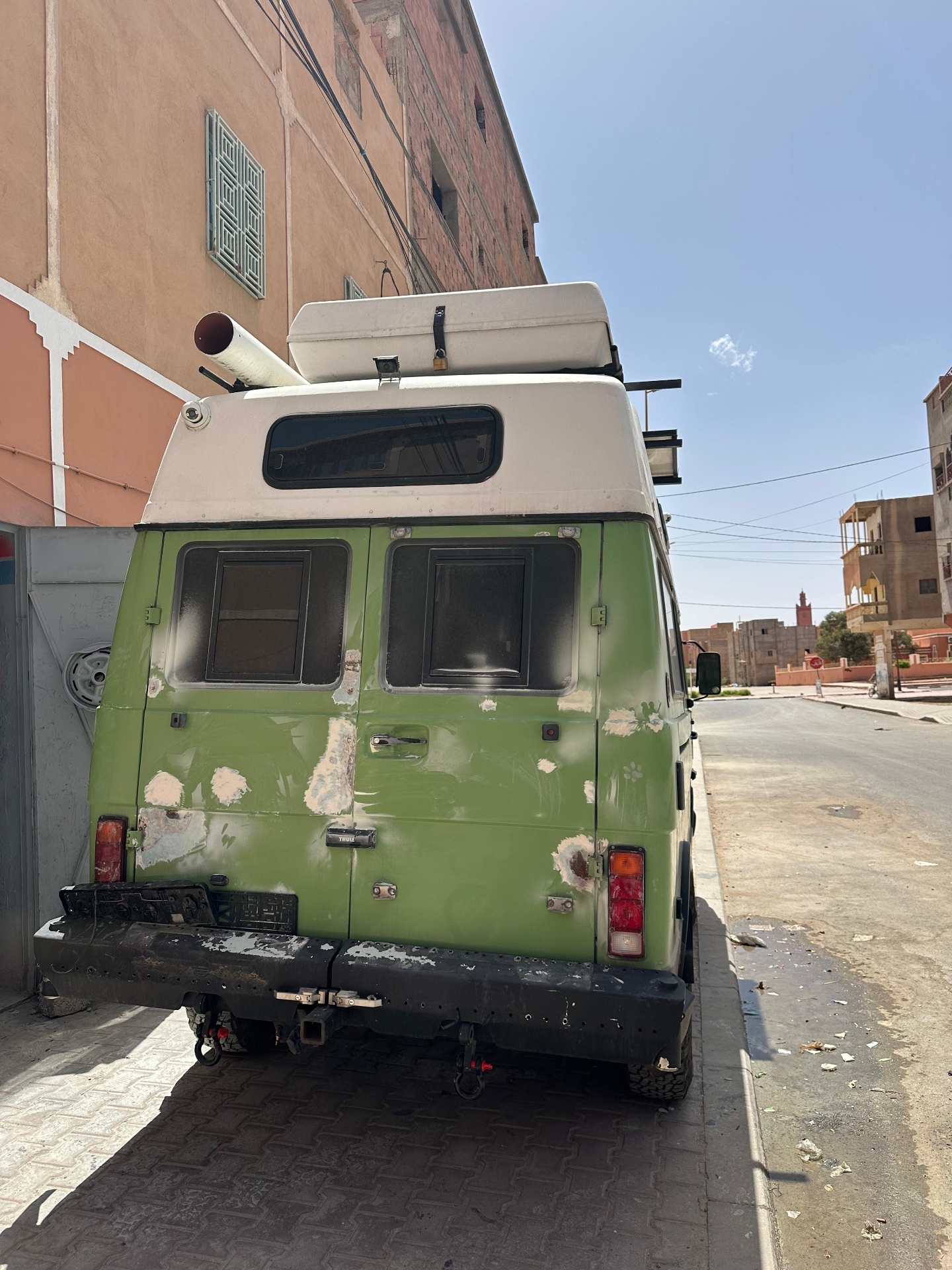 Belarusian VW camper van in original faded green paint with primer spots parked outside Garage Iriki Zagora before the repaint