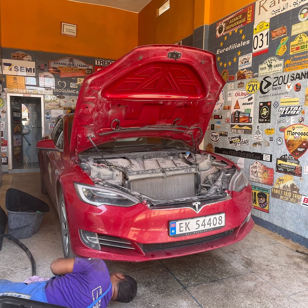Second view of the red Norwegian Tesla Model S on the workshop floor at Garage Iriki, Zagora