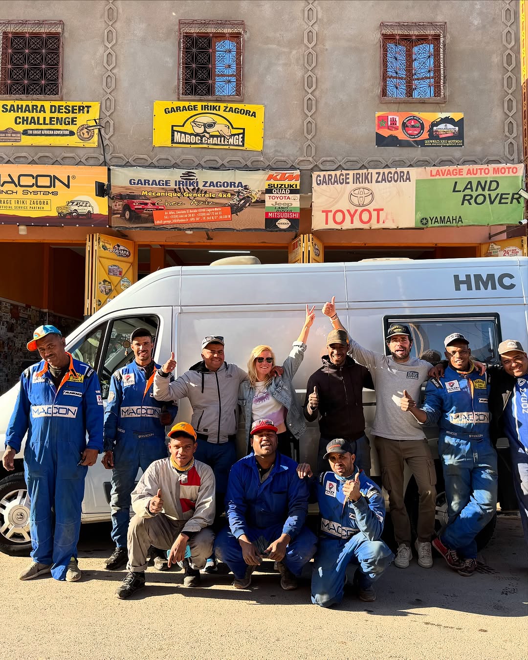 Garage Iriki Zagora team and the Dutch owners posing thumbs-up in front of the silver Peugeot Boxer HMC camper after the engine swap