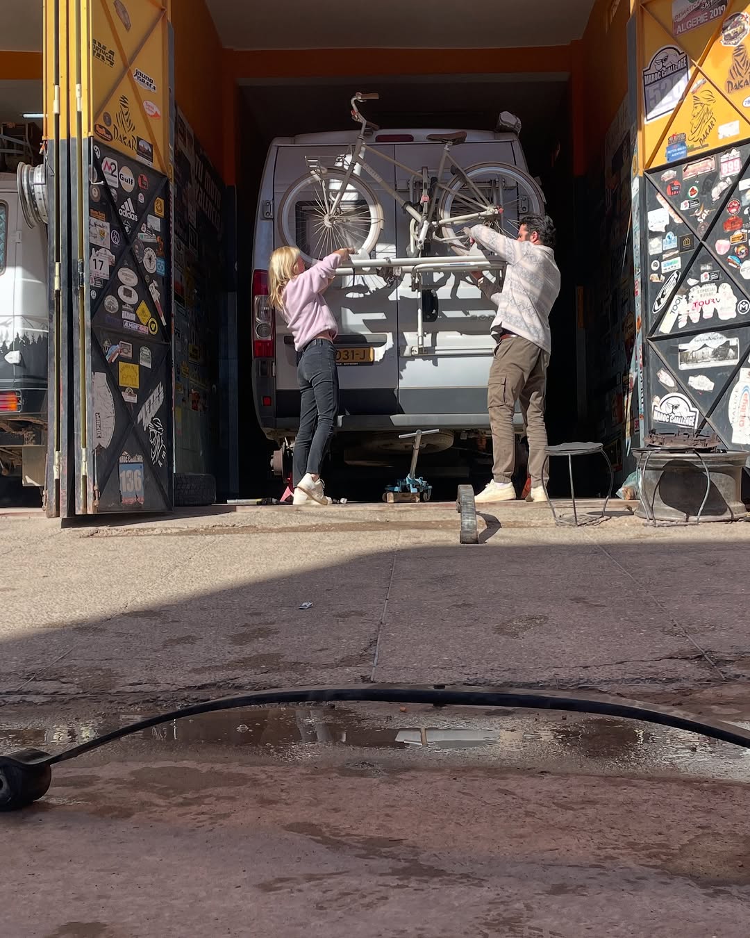 Dutch owners fitting the bike rack back onto the rear of the Peugeot Boxer after the engine and suspension work