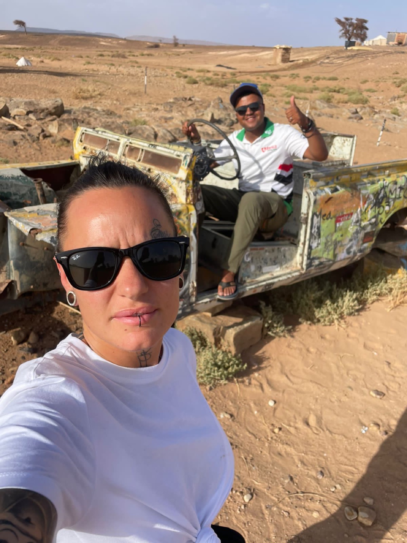 Zakaria beside a classic vehicle in an old Zagora street