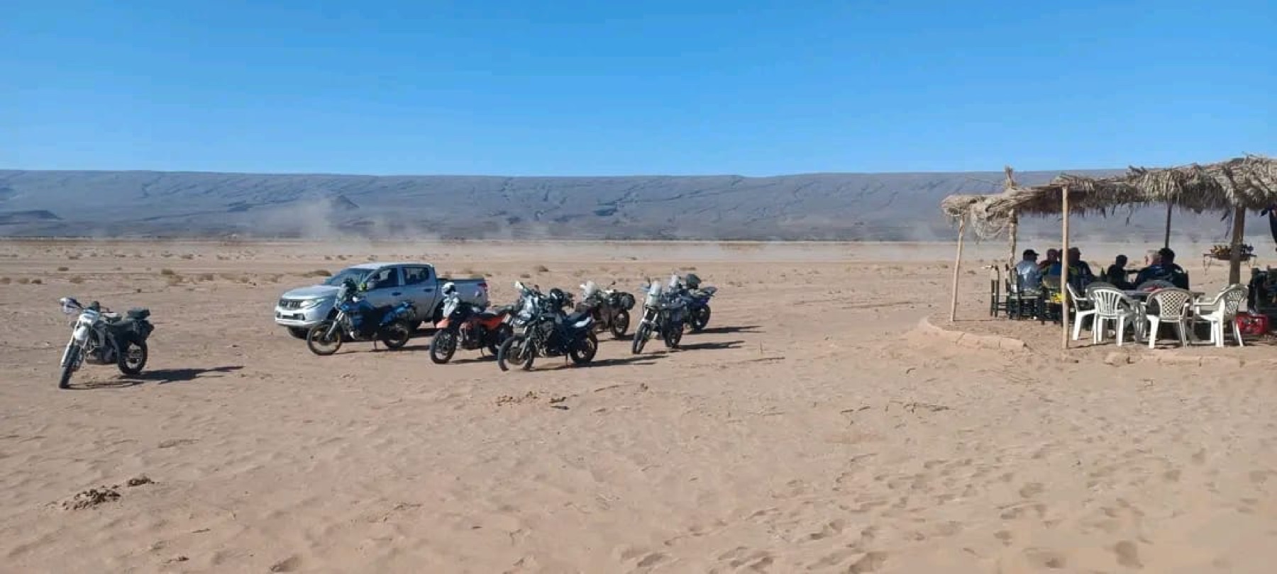 Motorcycles and a support vehicle on a desert route