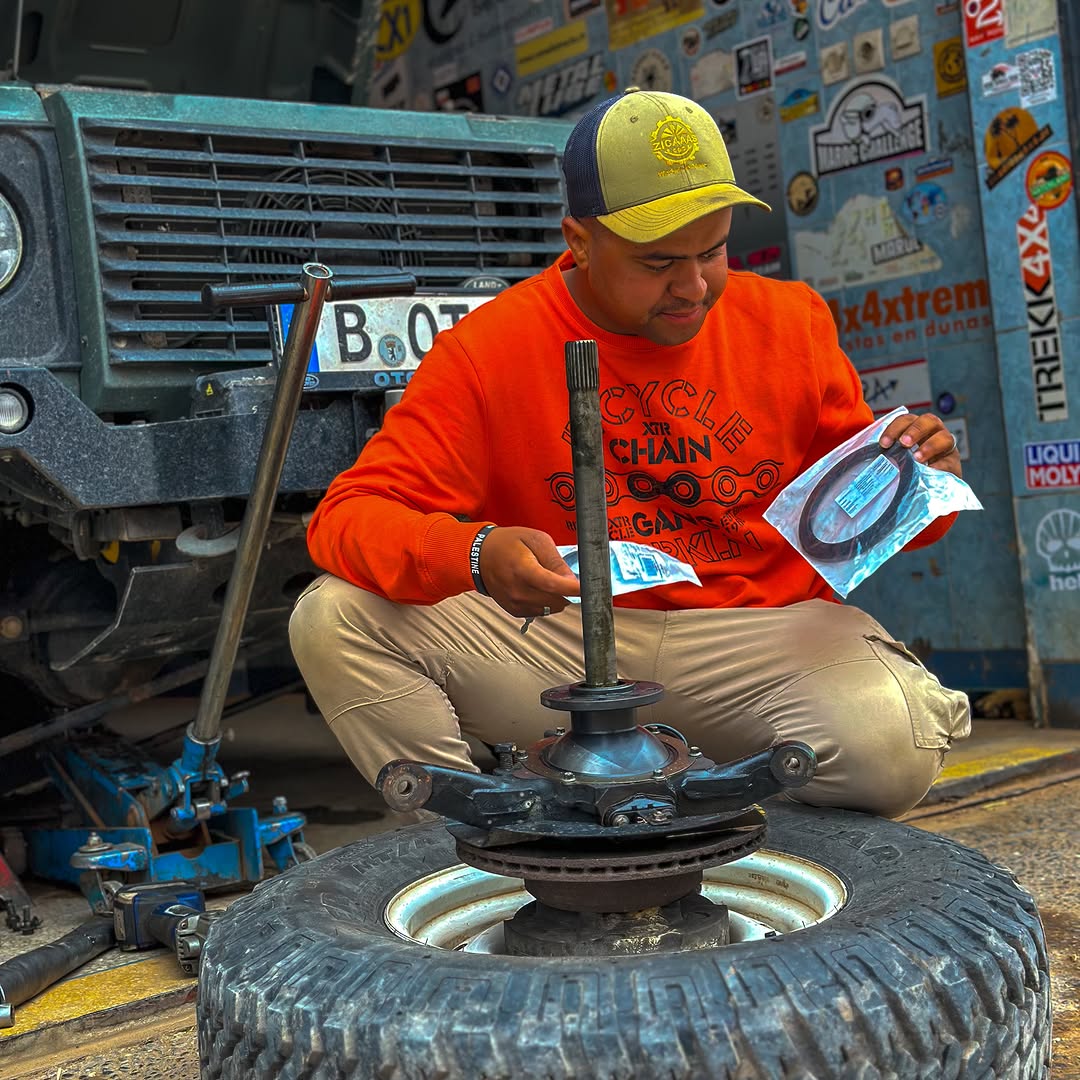 Zakaria fitting new oil seals onto the Defender stub axle and swivel hub in the workshop
