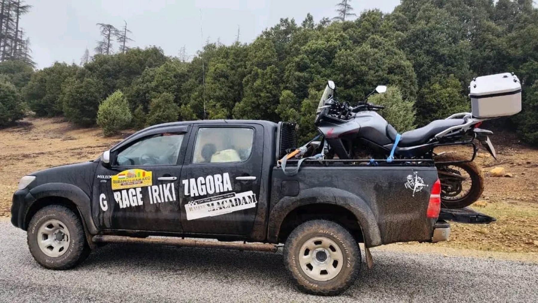 A support vehicle transporting a motorcycle across Morocco