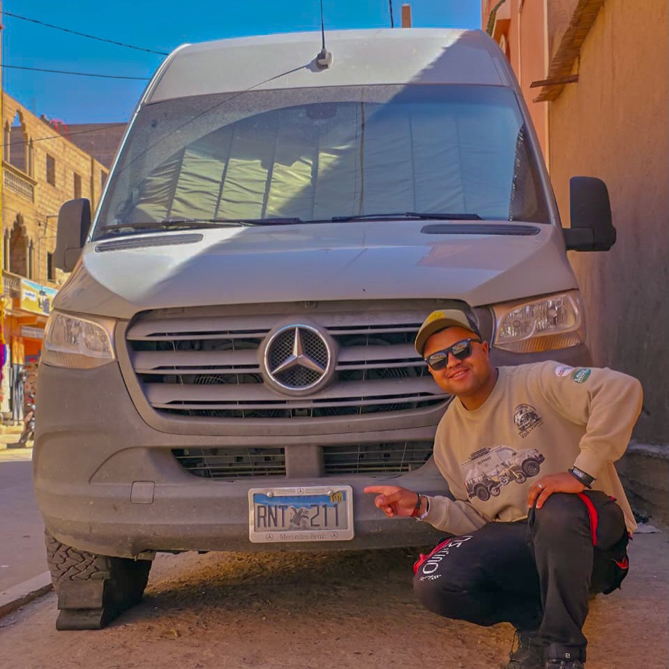 Zakaria (Zicaaaas) crouched next to the Colombian Mercedes Sprinter after the suspension work in Zagora
